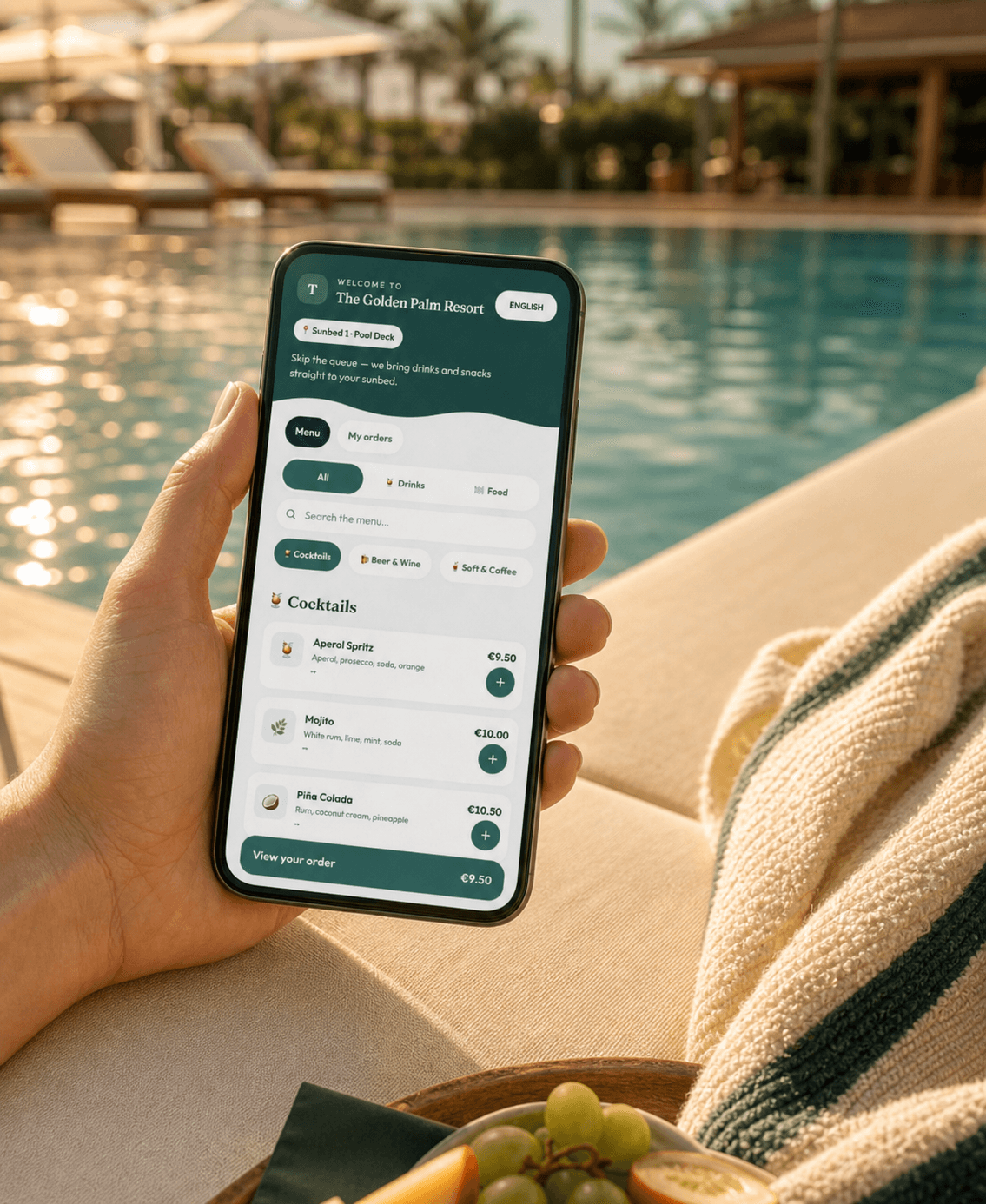 A hotel guest opening the Sunhail menu beside a resort pool